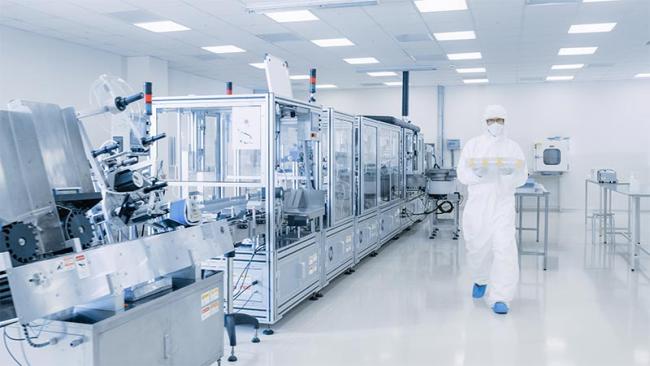 Operator walking in pharmaceutical laboratory cleanroom