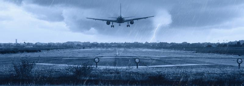 Airplane landing to in a stormy weather to a runway at the airport