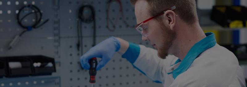 Service operator working on refractometer with screwdriver