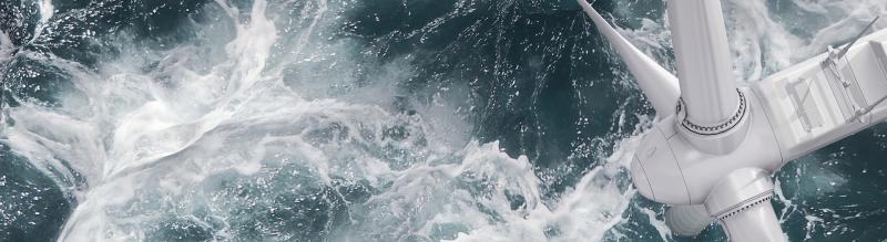 Aerial panorama of a close up wind turbine on the ocean
