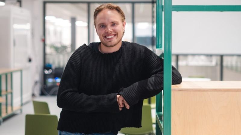 Giant Leap intern smiling at the camera in Vaisala R&D building