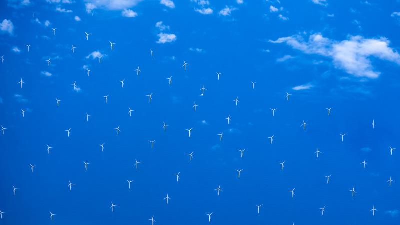 Modern windmills in an offshore wind farm in Northern Europe