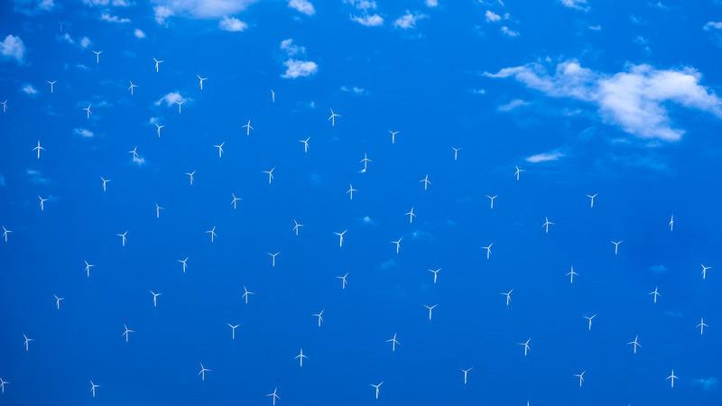 Modern windmills in an offshore wind farm in Northern Europe