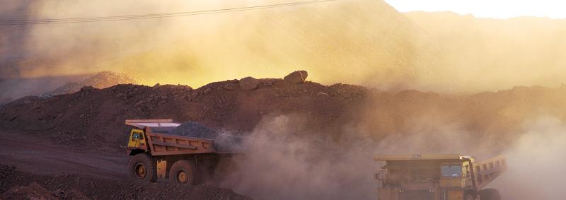 Big trucks working in a dusty mine