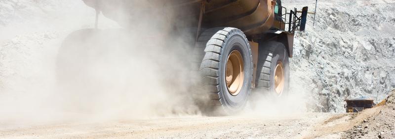 Truck driving through dusty mine