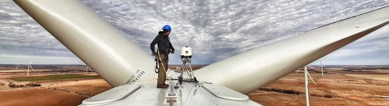 Engineer on top of wind turbine