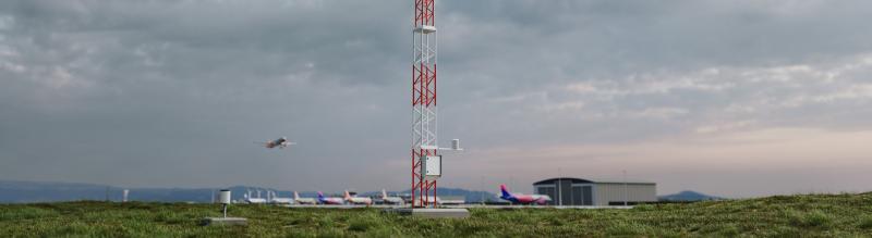 AWS810 pictured at airport with plane flying in the background.