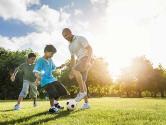 A family playing football outside.