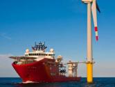 Ship next to offshore wind turbine