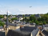 View of Luxembourg with plane flying in the sky