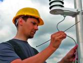 Engineer installing outdoor HVAC sensors