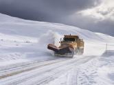Yellow snow plow clearing snow