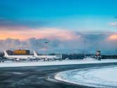 Aircraft at International Airport terminal at sunrise.