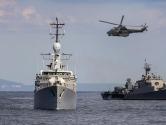 Military vessels at sea with helicopter above