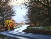 Council gritter spreading salt on a rural road in Wharfedale Yorkshire England UK