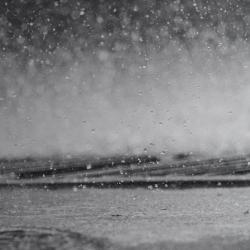 Rain hitting a puddle closeup