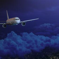 Passenger jet wide body plane in the dark night sky. Airplane flying high above the night Earth.