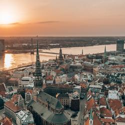 RIga rooftop view panorama at sunset with urban architectures and Daugava River. View of the old town