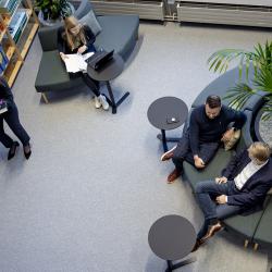 Vaisala employees working and talking in the office