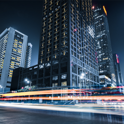 Car lights in a city  and modern office buildings