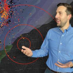 Hans Loewenheath stands in front of a map showing lightning activity around Dallas Fort Worth airport