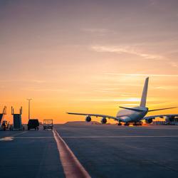 Plane taking off at sunset