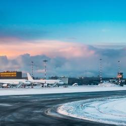 Aircraft at International Airport terminal at sunrise.