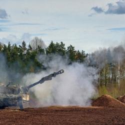 Latvian self propelled howitzer firing in the smoke