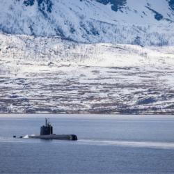 Military submarine by a snowy coast