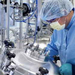 Chemical laboratory technician working in laboratory.