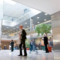 People walking through a building lobby.