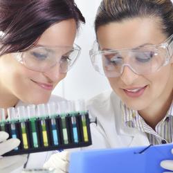 Two scientists with indicators and test results for microbial levels