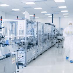 person in pharmaceutical laboratory cleanroom