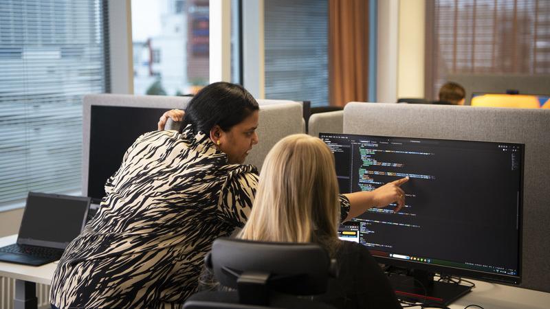 Two people at a computer.