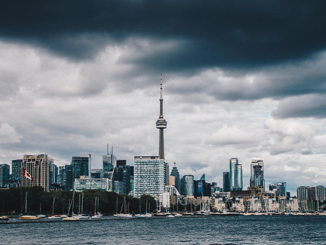 Storm clouds over city on water